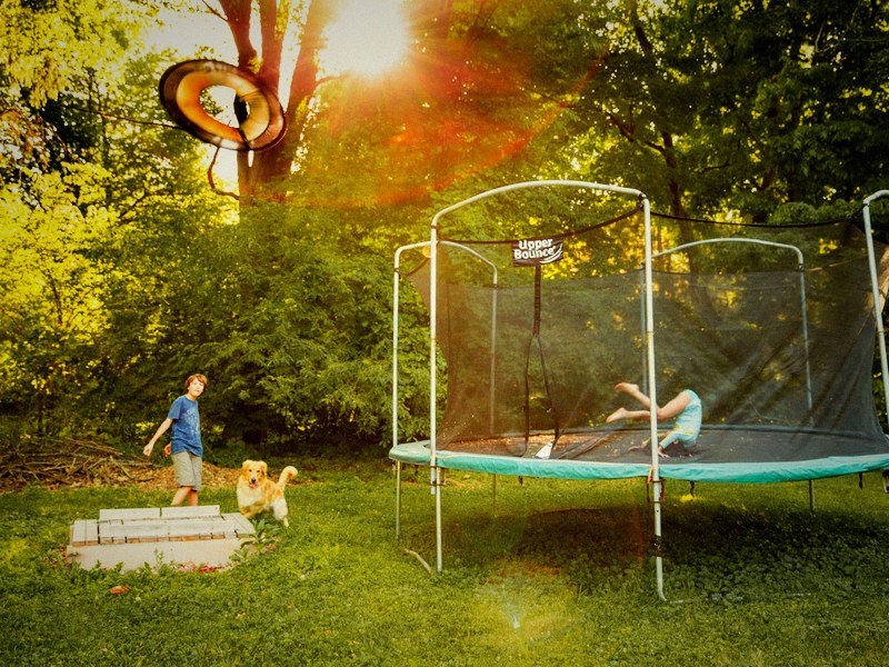 Children playing on a garden trampoline